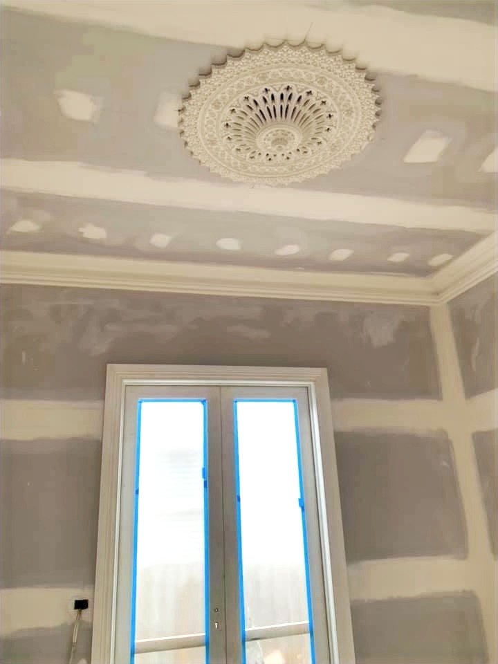 Interior room with decorative ceiling and cornice